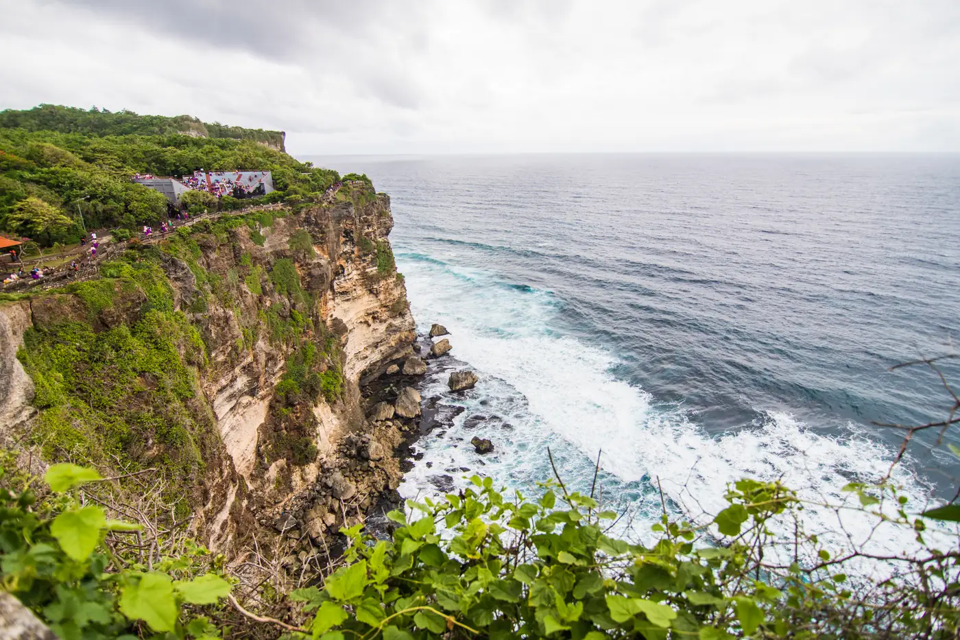Uluwatu temple on a green clifftop above the Indian Ocean in Bali
